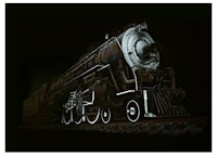 an image of a steam locomotive in the dark