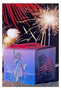 a box with fireworks and a statue of liberty