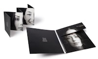 a black and white brochure with a woman's face on it