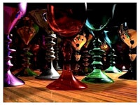 a group of colorful wine glasses on a wooden floor