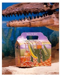 a box with a dinosaur in it next to a t-rex